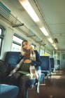 Beautiful pregnant woman talking on mobile phone while travelling in train — Stock Photo