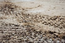 Close-up of bulldozer track on mud at construction site — Stock Photo