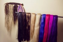 Close-up of artificial dreadlocks materials hanging in shop — Stock Photo