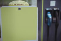 Close-up of yellow placard at electric vehicle charging station — Stock Photo