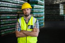 Retrato de jovem trabalhador do sexo masculino em pé no armazém — Fotografia de Stock