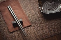 Close-up of chopsticks on dining table in restaurant — Stock Photo