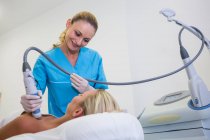 Woman receiving laser epilation treatment on body at beauty salon — Stock Photo
