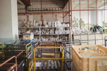 Vetreria vuota sistemata sullo scaffale in officina presso la fabbrica di soffiaggio del vetro — Foto stock