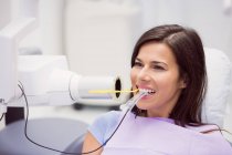 Female patient receiving dental treatment at dental clinic — Stock Photo