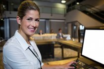 Portrait of female staff working in airport terminal — Stock Photo