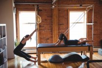 Determined women practicing pilates in fitness studio — Stock Photo