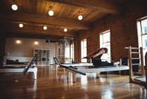 Determined woman practicing pilates in fitness studio — Stock Photo