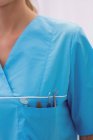 Mid section of dentist carrying dental tools in pocket in dental clinic — Stock Photo