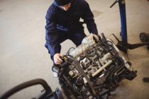 Mechanic checking a car parts in repair garage — Stock Photo