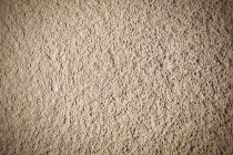 Primer plano de textura de arena de playa beige natural - foto de stock