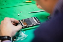 Close-up of man repairing mobile phone in repair center — Stock Photo