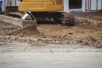 Bulldozer levelling mud at construction site — Stock Photo