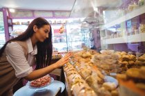 Beautiful woman looking at turkish sweets on display in shop — Stock Photo