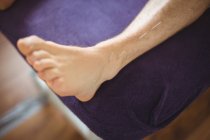 Close-up of patient getting dry needling on leg — Stock Photo