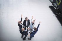 Business people standing with hands raised — Stock Photo