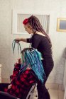 Beautician styling clients hair in dreadlocks shop — Stock Photo