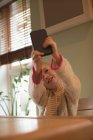 Elementary age girl taking selfie on mobile phone at home — Stock Photo