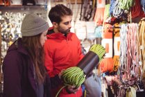 Couple selecting climbing rope together in a shop — Stock Photo