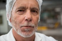 Close up portrait of male worker in factory — Stock Photo