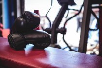 Пара боксерських рукавичок на лавці в фітнес-студії — стокове фото