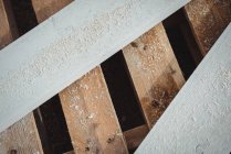 Close-up of wooden planks with sawdust at construction site — Stock Photo