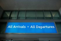 Departure and arrival information board sign at airport — Stock Photo