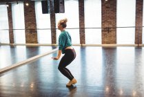 Donna che pratica una danza in studio di danza — Foto stock