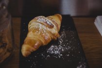 Nahaufnahme eines Tabletts mit gebackenem Croissant im Café — Stockfoto