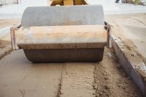 Road roller levelling mud at construction site — Stock Photo