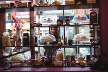 Beautiful woman looking at turkish sweets in shop — Stock Photo