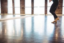 Низька частина жінки, що практикує танець в танцювальній студії — стокове фото
