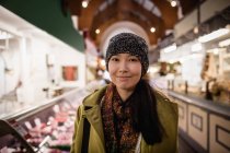 Портрет усміхненої жінки, що стоїть у супермаркеті — стокове фото