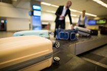 Baggage on conveyor belt in airport terminal — Stock Photo