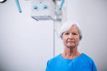 Portrait of senior woman undergoing an x-ray test in hospital — Stock Photo