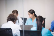 Doctor interacting with colleagues in meeting at conference room — Stock Photo