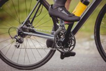 Low section of male athlete riding bicycle — Stock Photo