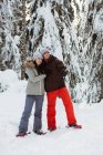 Счастливая пара лыжников делает селфи на заснеженной горе — стоковое фото