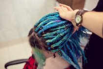 Close-up of beautician styling clients hair in dreadlocks shop — Stock Photo