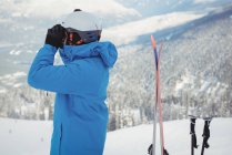 Лыжник смотрит на гору через бинокль — стоковое фото
