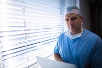 Portrait of surgeon using laptop at hospital — Stock Photo
