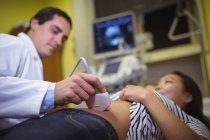 Female patient receiving a ultrasound scan on the stomach in hospital — Stock Photo