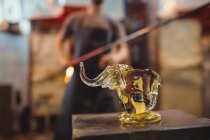 Close-up of showpiece figure made from a molten glass at glassblowing factory — Stock Photo
