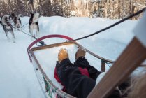 Close-up of woman riding sledge on a snowy land — Stock Photo