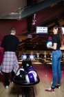 Friends playing bowling in bar — Stock Photo
