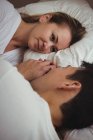 Romantic couple lying on bed in bedroom — Stock Photo