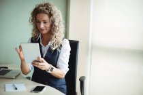 Businesswoman using digital tablet in office — Stock Photo