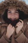 Portrait of smiling woman in fur jacket during winter — Stock Photo