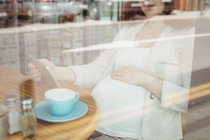 Беременная деловая женщина с цифровым планшетом в офисной столовой — стоковое фото