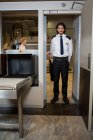 Security guard standing under the scanning door in the airport terminal — Stock Photo